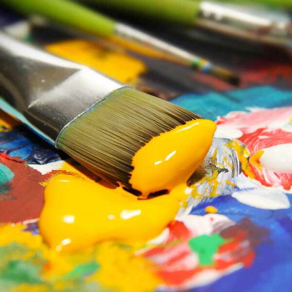 Simple art materials arranged on a calm desk with paper and pencils